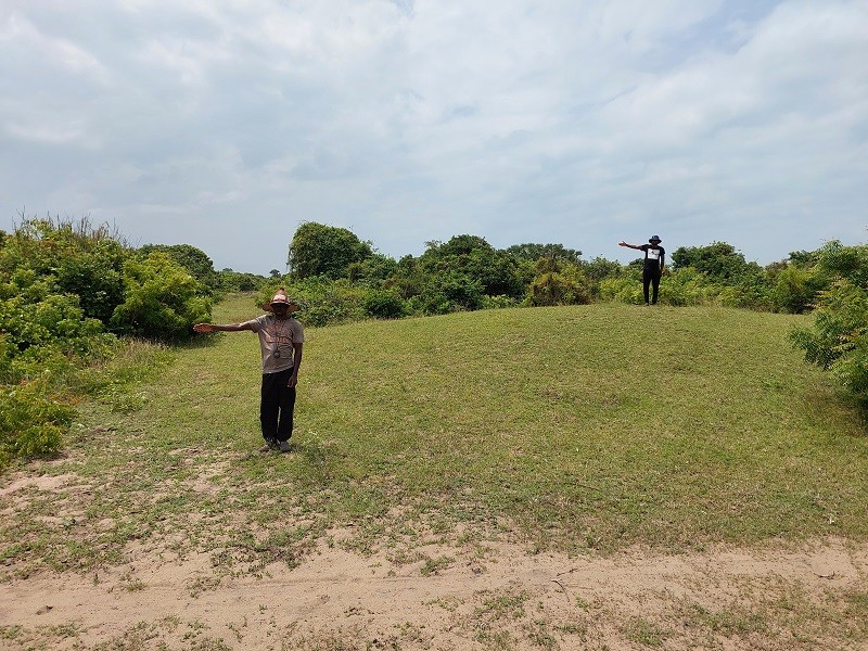 Abiola and RA measuring a mound