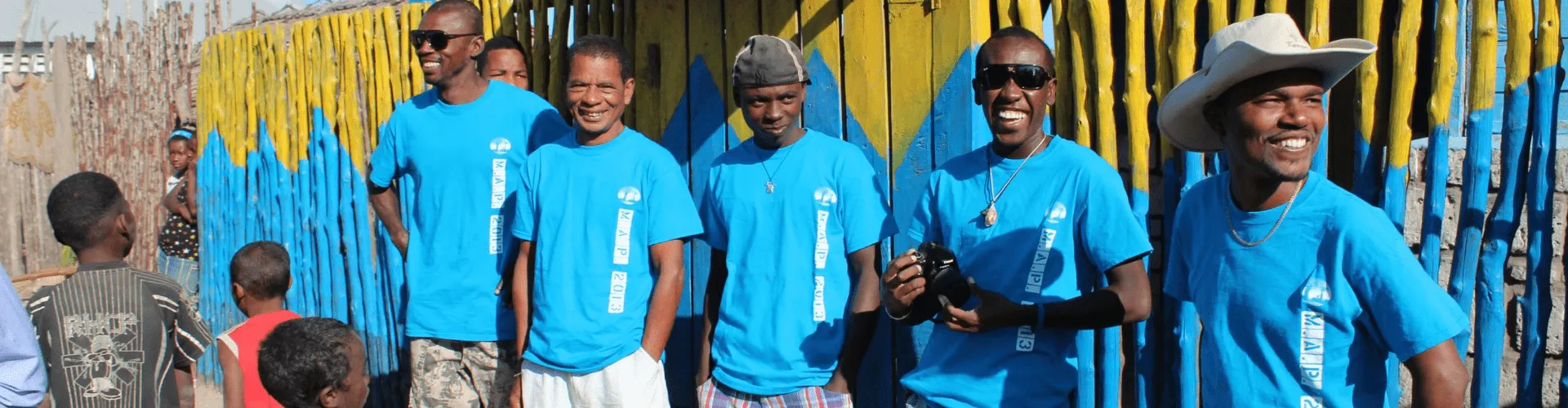 Group of people in matching blue t-shirts that say MAP 2013